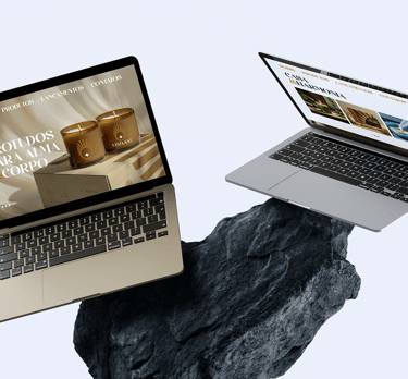 mockup of two laptops with the Luz & Axé website on top of a blue rock