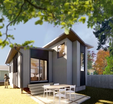 Modern grey detached ADU with a butterfly roof and patio furniture