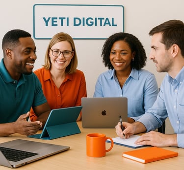 a group of people sitting around a table with laptops