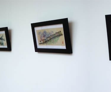 a hallway with framed pictures of a hallway
