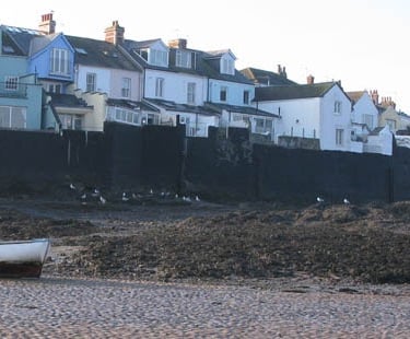 a boat sitting on the shore of a beach