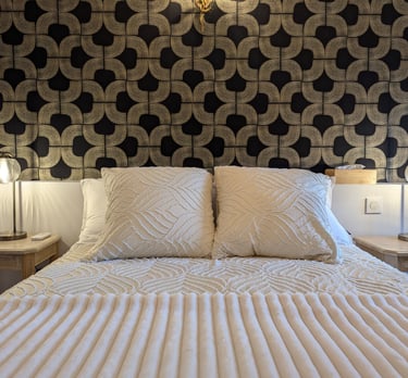 a bed with a white bed and a lamp