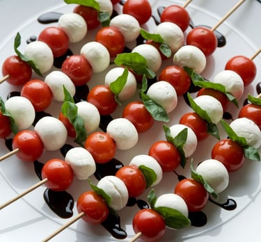 a plate of mozzarella tomatoes and mozzarella cheese skewers