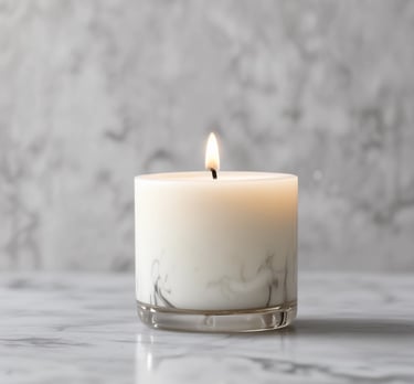 Close-up of a hand pouring natural wax into a candle mold.