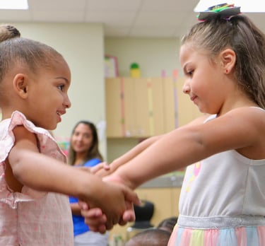 young girls holding hands and moving