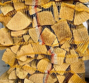Kiln dried hardwood logs in nets