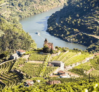 a boat sailing on a river in the middle of a valley