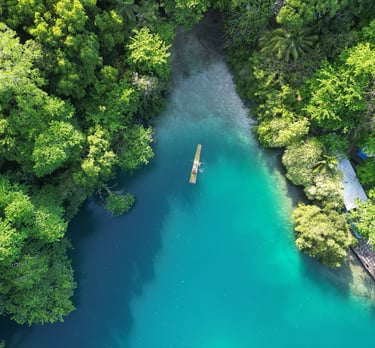 a boat floating in blue lagoon, jamaica
