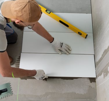 a man is working on a tile floor