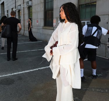 Street style at NYFW 2025 with guest in layered white suit.
