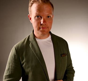 Nick Reese, AI, quantum, space expert in green blazer looking at camera