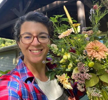 Candace the flower farmer holding a bouquet of flowers.