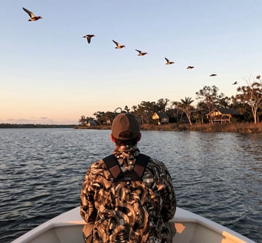 Sunrise over a misty marsh with a boat ready for duck hunting