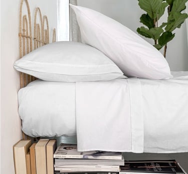 Stack of durable hotel pillowcases for commercial laundry