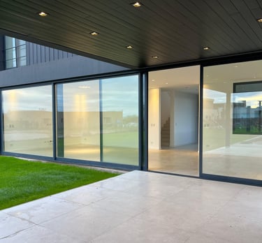 a large open glass door with a view of a patio