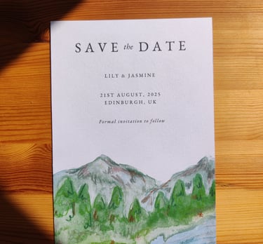 a save the date with an illustration of a mountain