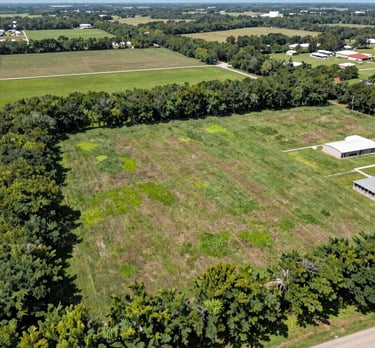 A wide aerial view of a 60-acre raw land parcel in Texas, ready for residential development.