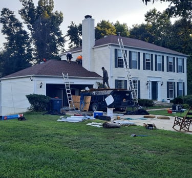 Roofing contractors working on a home in Northern Virginia providing roof replacement and repair services