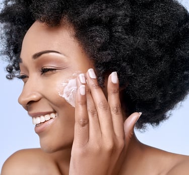 woman applying ori shea mousse to her face