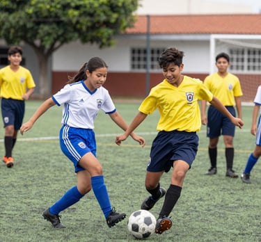 Outdoor sports event with students playing soccer on a sunny day.