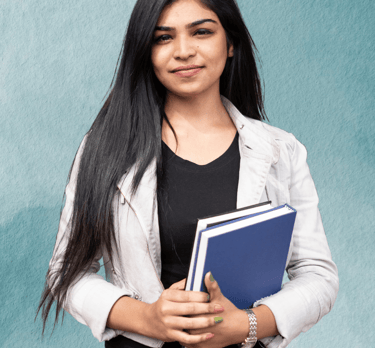 "Teacher standing with books in hand, ready to guide students in their learning."