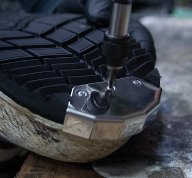 a person repairing a pair of motocross boots