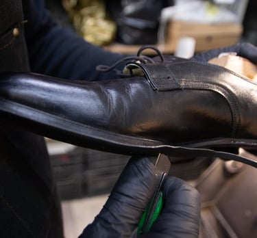 a person in gloves and gloves holding a shoe