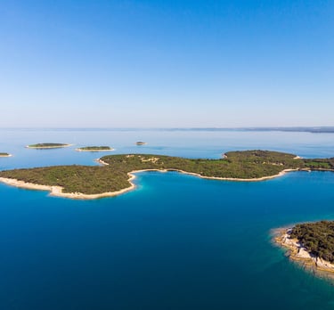 Scenic view of Brijuni National Park islands with lush greenery and turquoise waters.