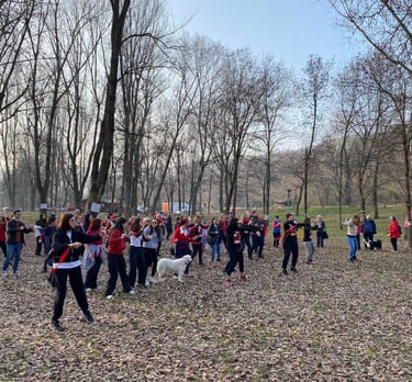 a group of people standing in a field with trees