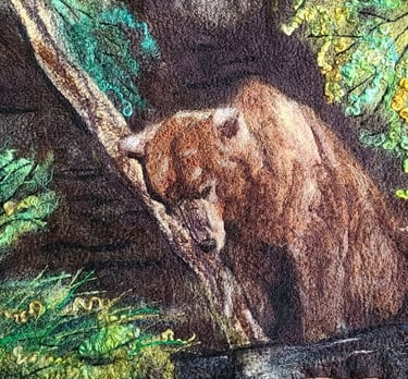 a wool painting of a sleeping brown bear