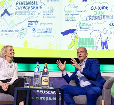 panel discussing in front of a graphic recording