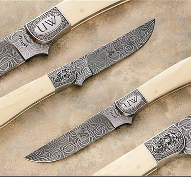 a group of custom engraved knives by Heritage Collectables