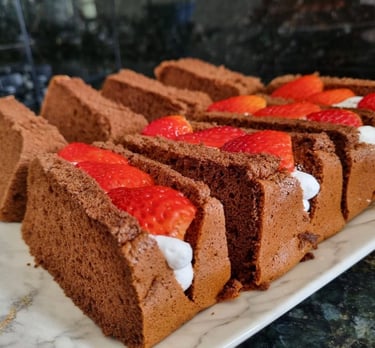 a cake with strawberries and whipped cream on a white plate