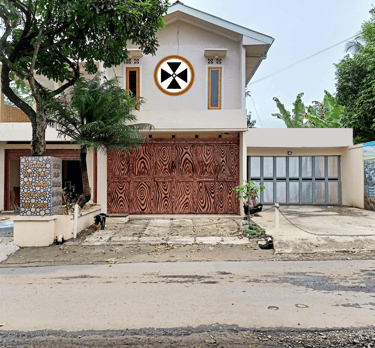 a house with a large wooden door and a large clock on the front of it