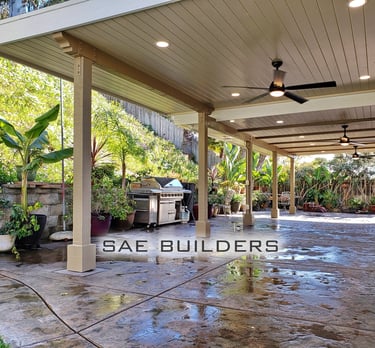 Split level wood outdoor patio area with recessed lighting and ceiling fans.