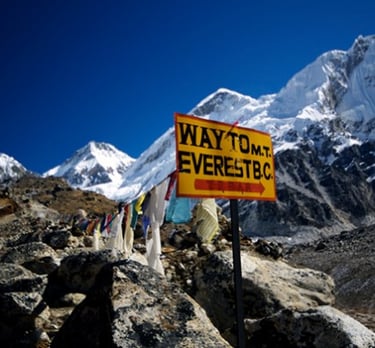 Yellow sign marking the trail to Mount Everest Base Camp in Nepal
