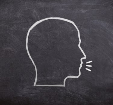 a drawing of a head talking on a chalkboard