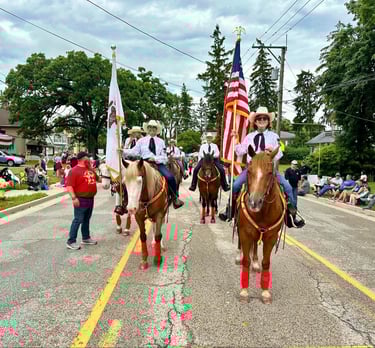 A group of people on horses during a parade,