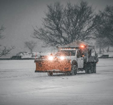 Ford truck plowing snow removal in commercial parking lot