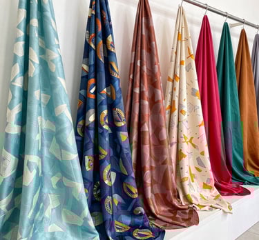 A vibrant roll of digitally printed fabric showcasing intricate patterns and bright colors.