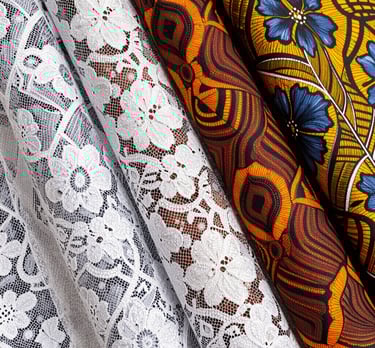 Elegant display of vibrant wax print fabrics draped gracefully on mannequins.