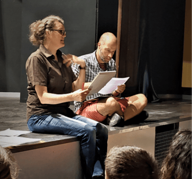 Teachers Harriet Thompson and Schuyler Hedstrom teaching a theatre class on a stage in Madrid
