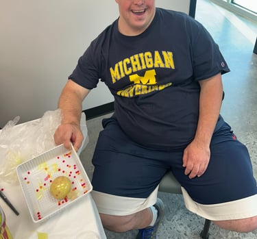 a man sitting at a table with a tray of food