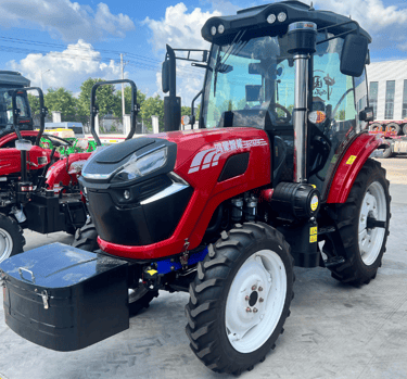 a red tractor with a black box on the back of it