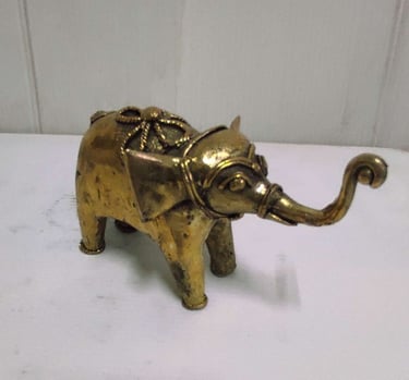 "Glossy brass baby elephant with tribal design carvings, right side view-for foreign markets"