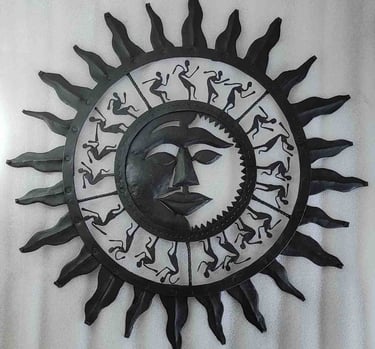 "Handcrafted iron wall art featuring sun face and dancing tribal figures–Bastar decor-for global markets"