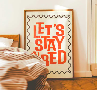 Let's Stay In Bed typography wall art for bedroom decor in warm retro colors