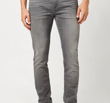 a man in a gray shirt and  gray jeans 