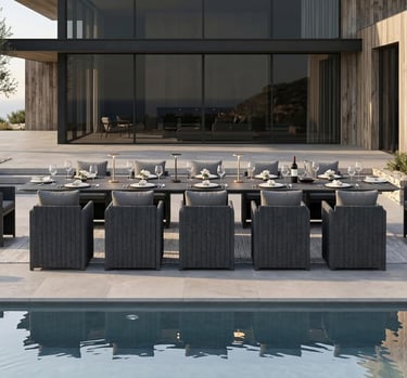 Modern outdoor dining set with long black table and gray wicker chairs by a luxury pool.