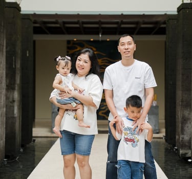 family walking together through resort entrance during a natural family photography session at Movenpick Jimbaran Bali